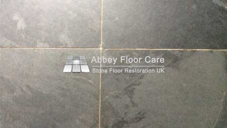 Dirty slate floor tiles in Matlock with a dull finish and ingrained soil